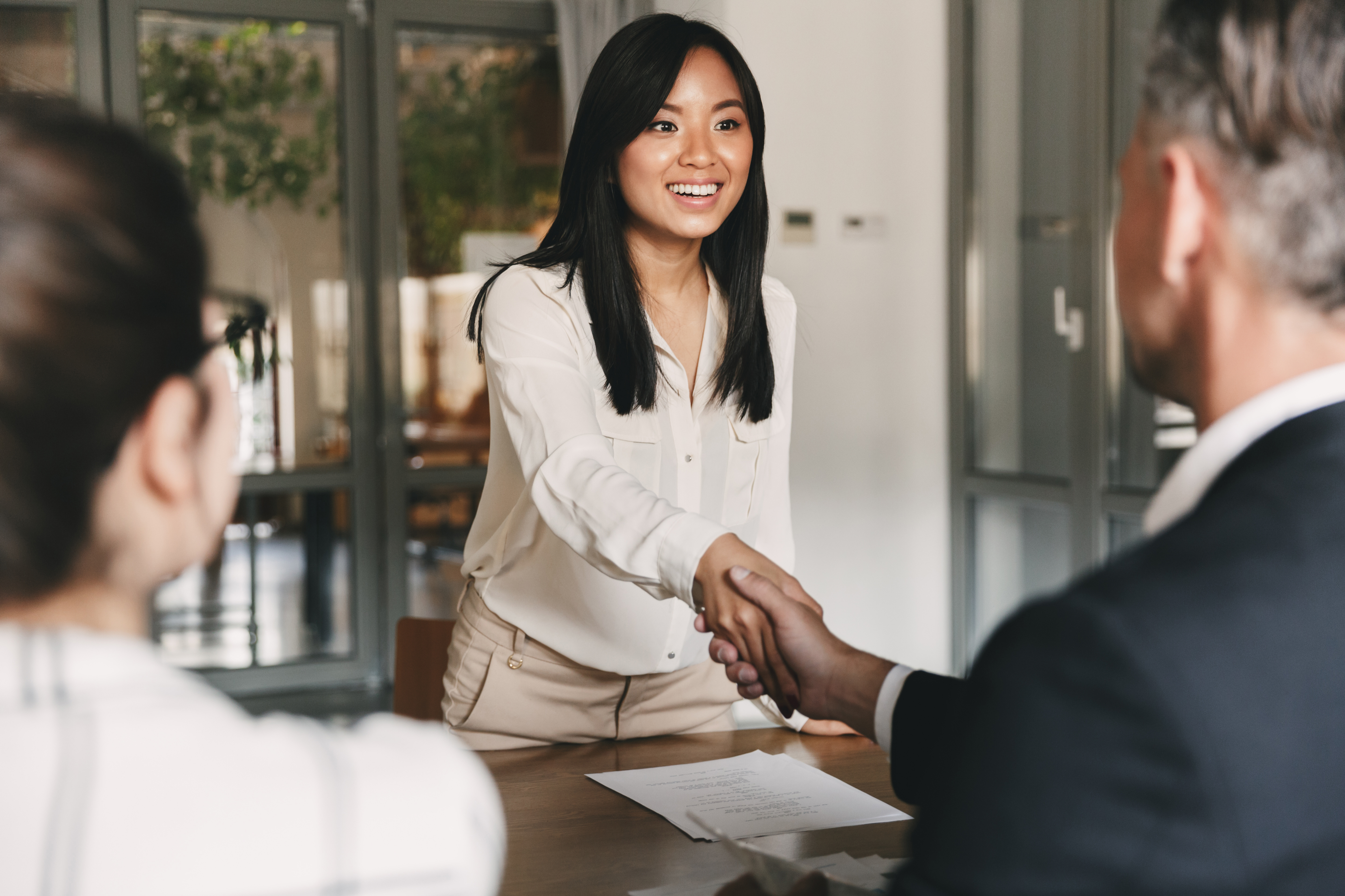 Education consultancy professional welcoming a candidate during a job interview at an international education agency.