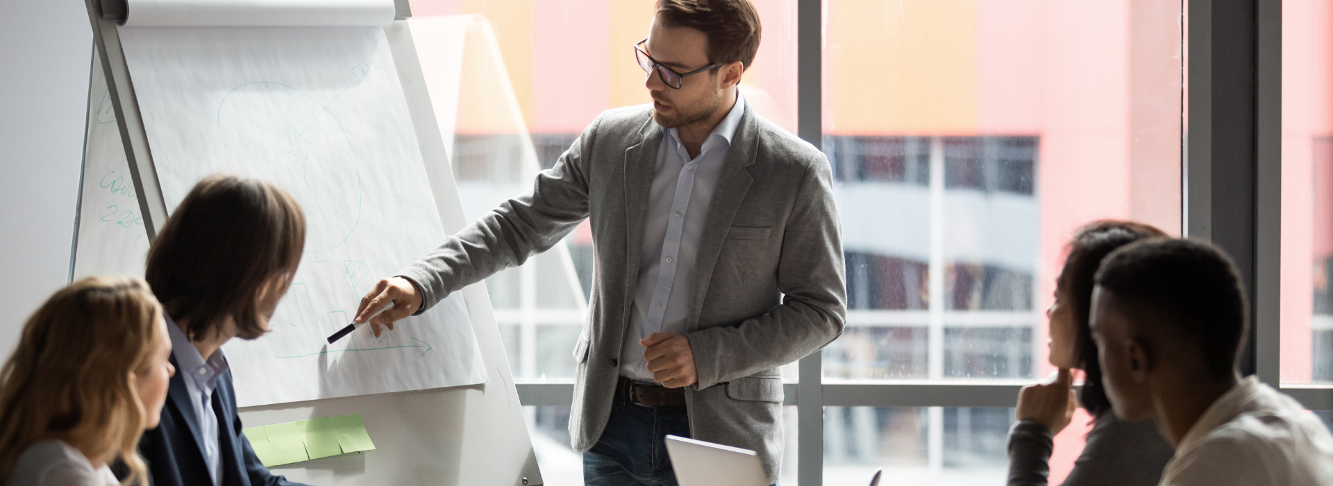Professionals attending a specialist training session led by an instructor in a modern classroom setting