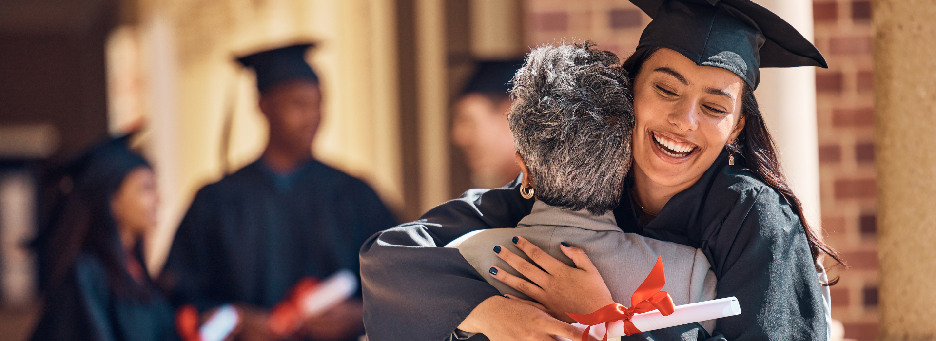 International student celebrating graduation with family support at a UK university ceremony